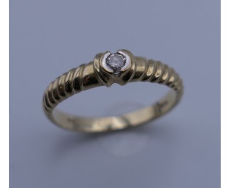 A 9 ct gold diamond solitaire ring. Ring size N. 2.1 grammes total weight.