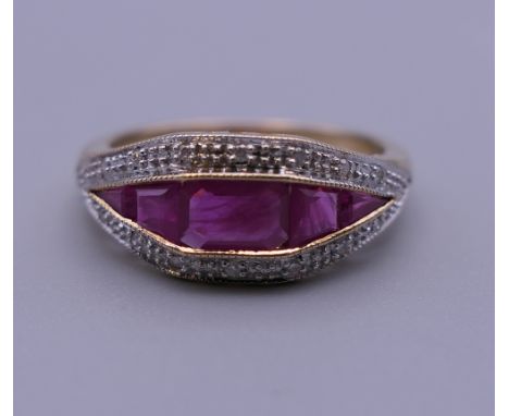 An Art Deco style 9 ct gold ruby and diamond ring. Ring size O. 3.4 grammes total weight.