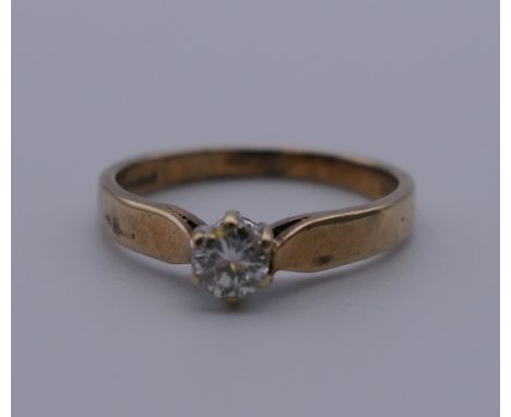 A 9 ct gold diamond solitaire ring. Ring size J. 1.4 grammes total weight.