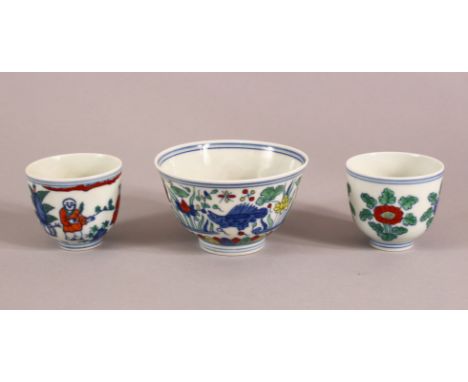 A SMALL GROUP OF MING STYLE DOUCAI CUPS, comprising one tea cup and two smaller ones, larger 9cm diameter, smaller 5.5cm diam