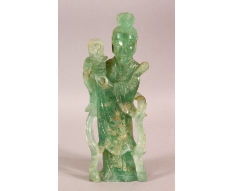 A CHINESE CARVED GREEN ROCK / JADE FIGURE OF A FEMALE FIGURE AND FLORA 24CM