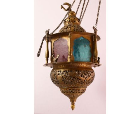 A GOOD BRASS QAJAR HANGING LAMP, with coloured glass panels, bird finial,  the actual lamp excluding chain 36cm
