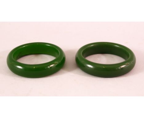 A PAIR OF CHINESE JADE BANGLES, both 8cm diameter.