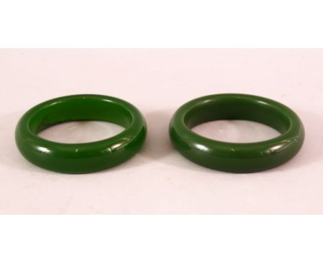 A PAIR OF CHINESE JADE BANGLES, both 8cm diameter.