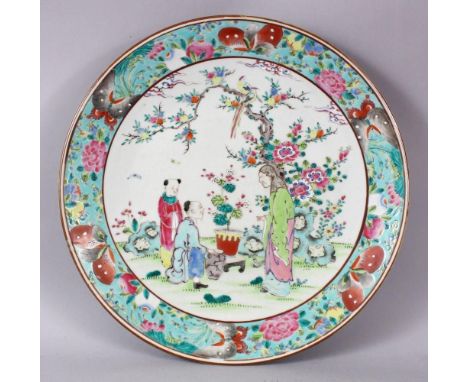 A 19TH CENTURY CHINESE FAMILLE ROSE PORCELAIN PLATE OF SCHOLARS, the decoration depicting a scholar and two figures in a land