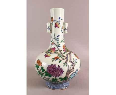 A CHINESE DOUCAI DECORATED PORCELAIN FRUIT VASE - with twin handles, decorated with native flowers and fruit, the base with a