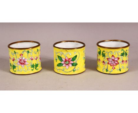 THREE CHINESE YELLOW ENAMEL NAPKIN RING HOLDERS, decorated with formal lotus decoration upon yellow ground, 5cm