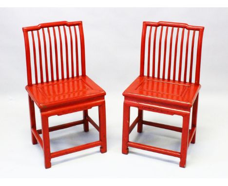 A PAIR OF CHINESE RED LACQUER STICK BACK SIDE CHAIRS, with panelled solid seats and stretchered square legs.