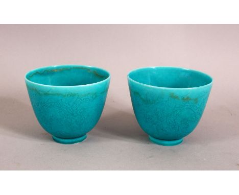 A PAIR OF CHINESE TURQUOISE GROUND TEA CUPS, decorated with dragons, the bases with a six character mark, 7.5cm diameter, 6cm
