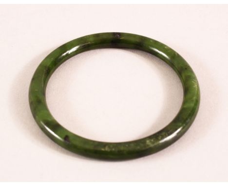 A CHINESE CARVED JADE BANGLE, 7.5cm