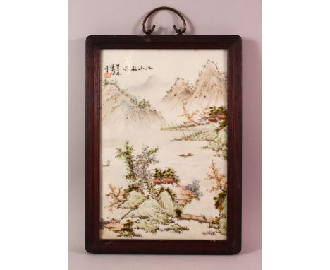 A CHINESE FAMILLE ROSE PORCELAIN FRAMED PANEL - depicting a landscape view with calligraphy and seal upper left - with hard w