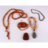 A BOX OF MIXED CHINESE BEADS AND TWO PENDANTS.