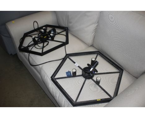 A pair of black metal light fittings 