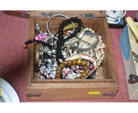 A trinket box and contents of various costume jewellery 