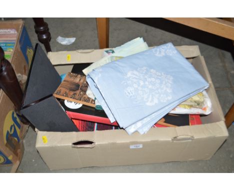A box containing various sundry items to include materials, snowman light, curtains etc. 