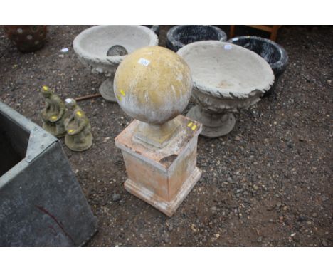 A plaster ball finial on plinth