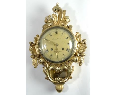 A Swedish giltwood wall clock by John Holme, the enamel dial bearing Roman and Arabic numerals, eight day movement, the case 