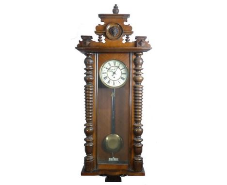 A Vienna mahogany cased wall clock, the white enamel dial bearing Roman numerals to the chapter ring, subsidiary seconds dial