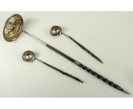 A George III silver toddy ladle with twisted whalebone handle and set with a 1787 Shilling to the bowl, 41cm long, and a pair