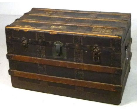 A Victorian travelling trunk with wooden straps, three front clasps and iron carrying handles, 81 by 41 by 45cm. 