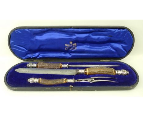 A Mappin and Webb cased carving set, with antler handles, and silver mounts, comprising a knife, fork and steel, Sheffield 19