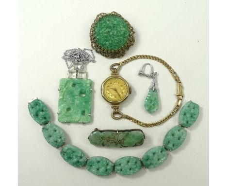 A jade brooch, circa 1920's, carved with a bat and fruit, Art Deco simulated jade pendant on chain, oval link bracelet and a 