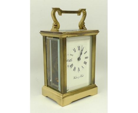 A modern brass and glass carriage clock by Walker and Hall, the white enamel dial bearing Roman numerals, complete with key, 