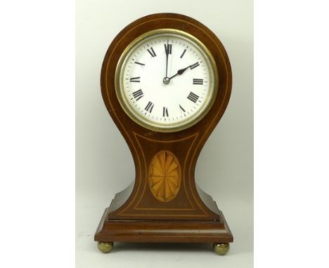 An Edwardian mahogany balloon clock, the white enamel dial bearing Roman numerals, French movement, the case with satinwood p