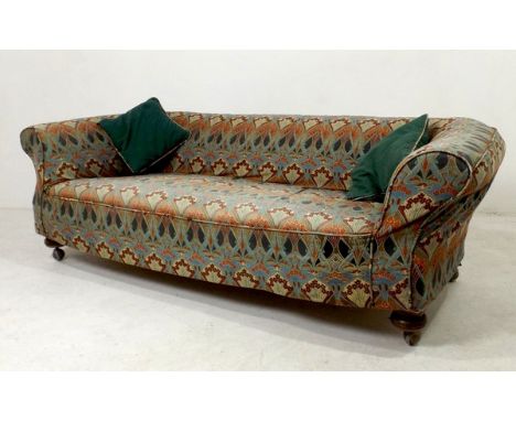 A Victorian three seater sofa upholstered in patterned cotton fabric, raised on turned legs, 214 by 90 by 67cm high.