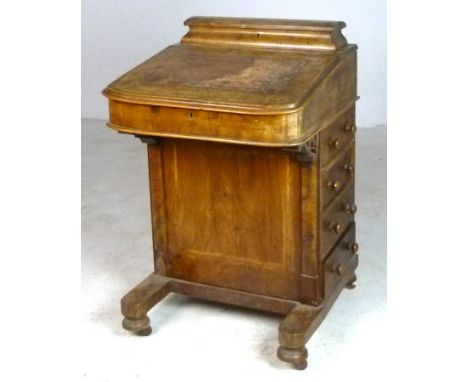 A 19th century Davenport with caddy top, drawers to the sides and raised on bun feet, 53 by 56 by 86cm high. 