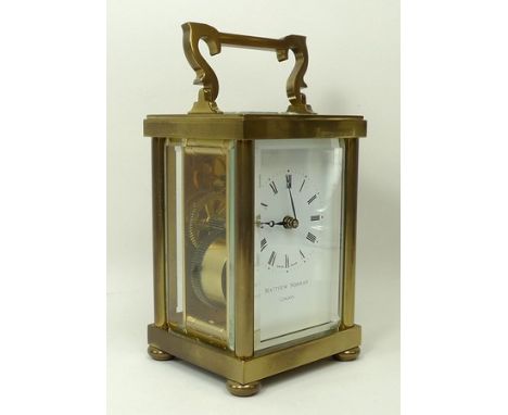 A brass carriage clock, the white dial with Roman numerals and marked Matthew Norman, London, the Swiss movement marked Matth