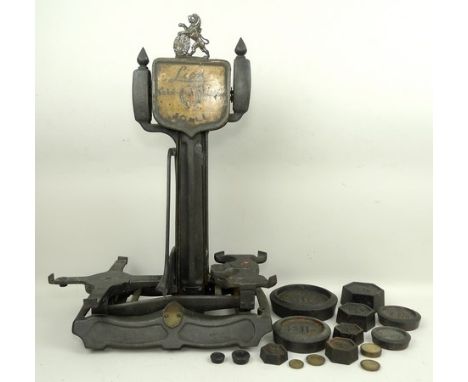 A set of Lion Quick Action cast iron scales with weights.