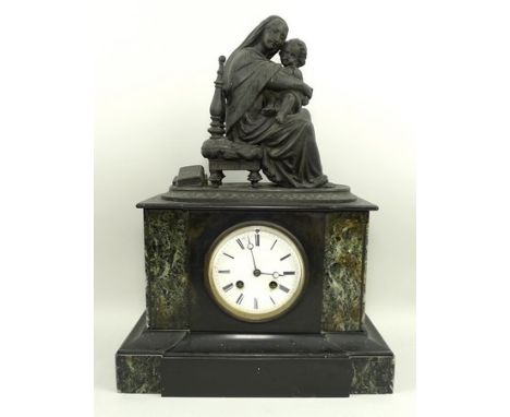 A Victorian slate mantel clock, the architectural case with green marble insets, surmounted by a spelter figurine of a seated