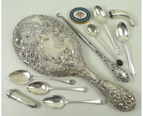 A silver backed hand mirror embossed with flowers and rococo scrolls, Birmingham 1904, a button hook with silver handle, silv