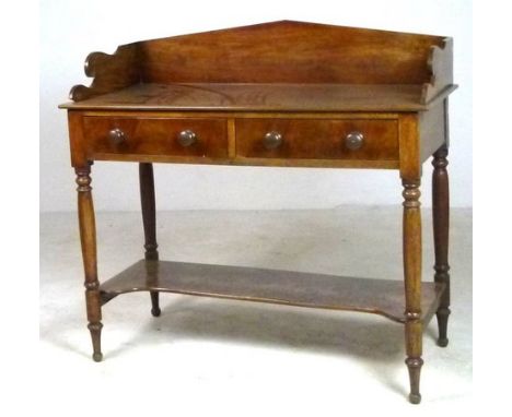 A Victorian mahogany wash stand with shaped back rail, two short drawers, turned legs and a low shelf, 108 by 53 by 102cm hig