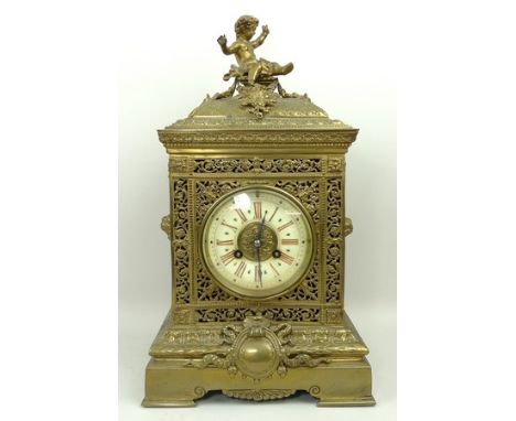 A Victorian brass mantel clock, the dial with enamel chapter ring bearing Roman numerals, eight day movement half hour striki