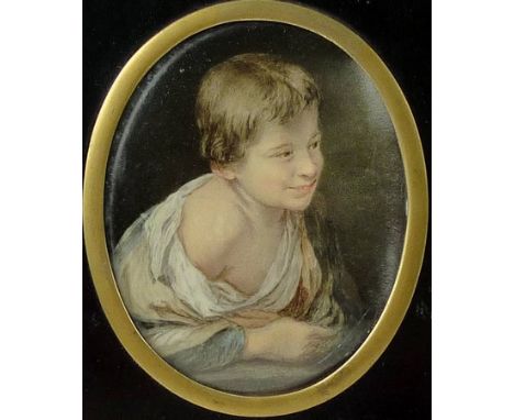 A 19th century miniature portrait of a young boy, unsigned, in an oval brass slip and ebonised papier mache frame with pendan