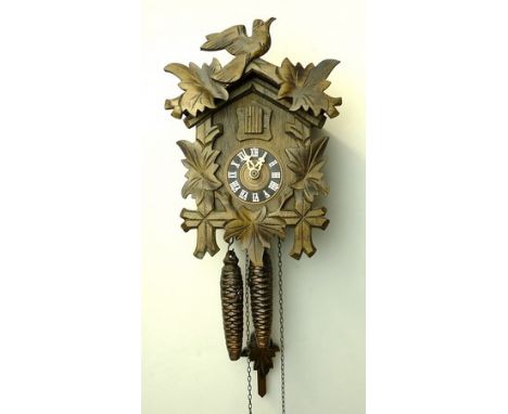 A Bavarian wooden cased cuckoo clock of traditional form with two train movement, 16 by 14 by 24cm. 