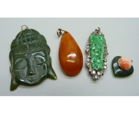 A jade and white stone set clip converted into a pendant, a coral set pendant and two other pendants 