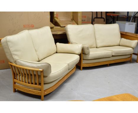 A 2 PIECE ERCOL CREAM LEATHER &amp; LIGHT OAK FRAMED LOUNGE SUITE COMPRISING 2 X 2 SEATER SETTEES    