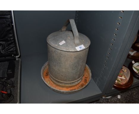 A vintage galvanized poultry drinker.