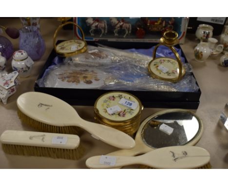 An assortment of vintage dressing table items including brushes, trinket boxes and candle stick holders with embroidered deta