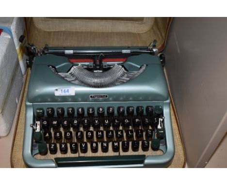 A cased Imperial Good Companion typewriter in metallic green