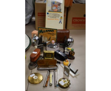 A selection of curios and collectables including art deco desk top calendar cigarette lighter and stratton compact