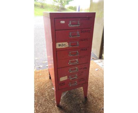 A collection of hand tools in an eight drawer filing cabinet.