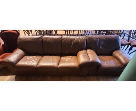 A modern brown leather upholstered three seater sofa, W210, D89, H83cm, together with a matching armchair, W210cm. (2)