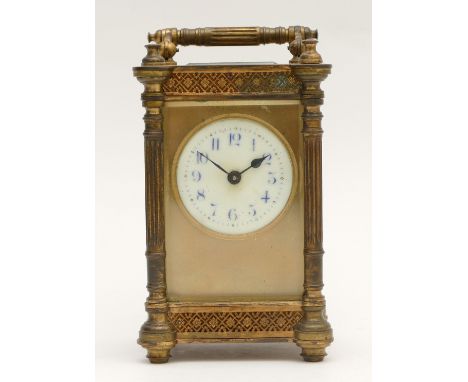 An early 20th century French gilt brass carriage clock, having painted porcelain dial with Arabic numerals with 8 day movemen