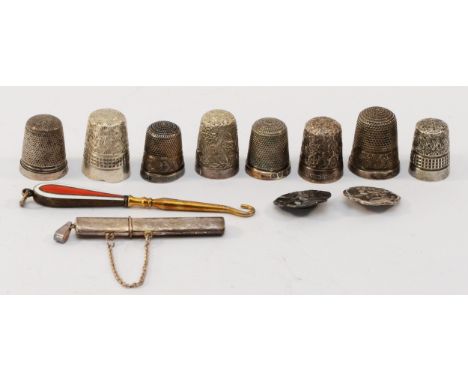 Eight silver thimbles, a silver and enamel button hook, two silver buttons and an unmarked silver needle case