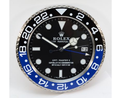 A 'Rolex' style advertising wall clock, blue and black surround with black dial reads 'GMT Master II' having quartz movement,