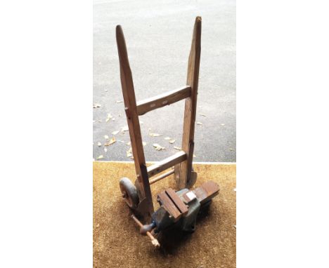 A vintage wooden sack barrow 104cm high x 45cm wide, also a Record 112 heavy duty bench vice.